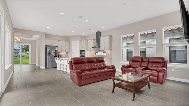 tiled living room featuring a notable chandelier and sink