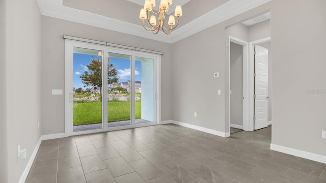 spare room featuring crown molding and a chandelier