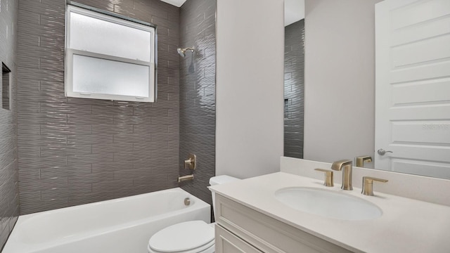 full bathroom with vanity, tiled shower / bath combo, and toilet