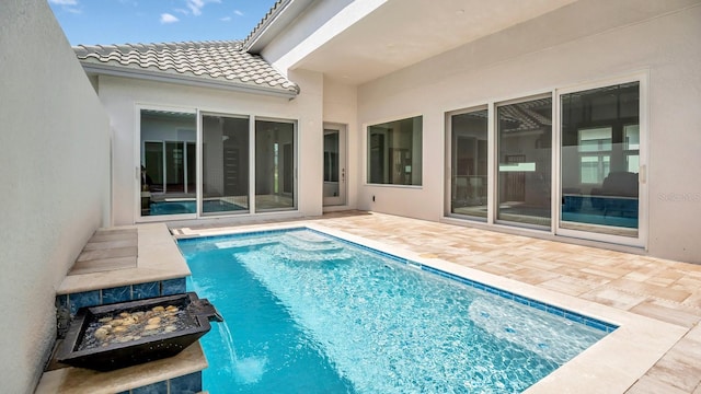 view of pool with pool water feature and a patio area