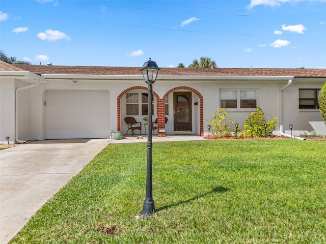 ranch-style home featuring a front lawn and a garage