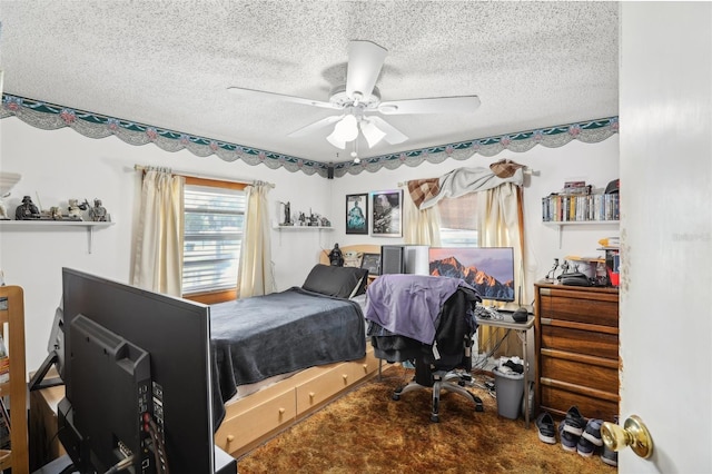 bedroom featuring a textured ceiling, carpet, and ceiling fan