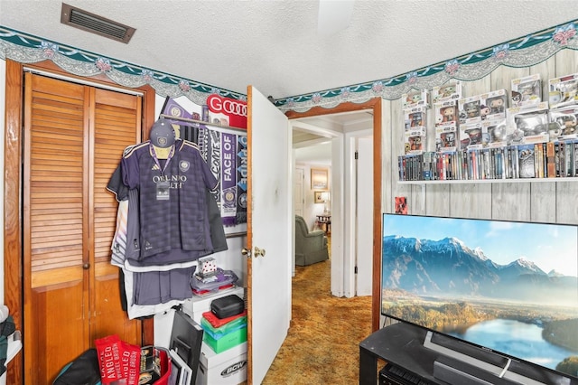 interior space featuring a textured ceiling and a closet