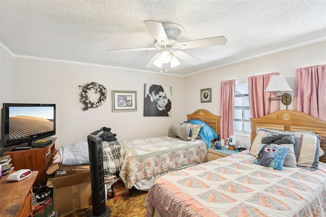 bedroom with ceiling fan, a textured ceiling, crown molding, and wood walls