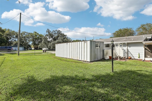 view of yard featuring a storage unit