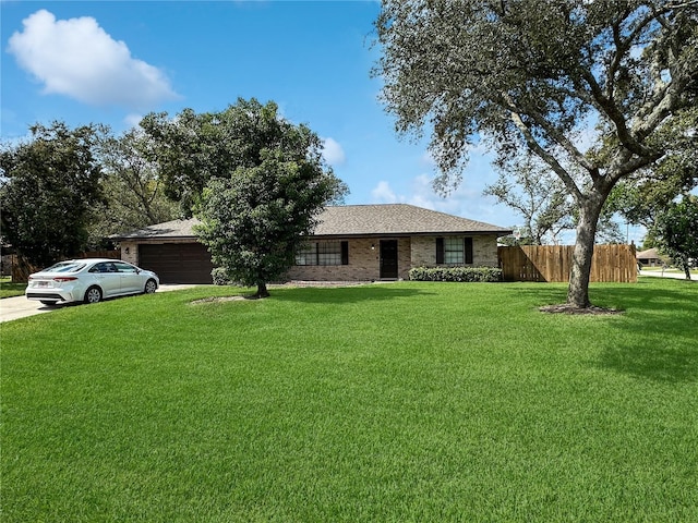 single story home featuring a garage and a front yard