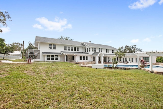 rear view of house featuring a lawn and a patio