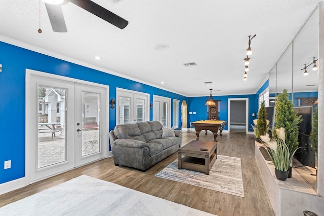 living room with french doors, hardwood / wood-style flooring, billiards, ceiling fan, and crown molding