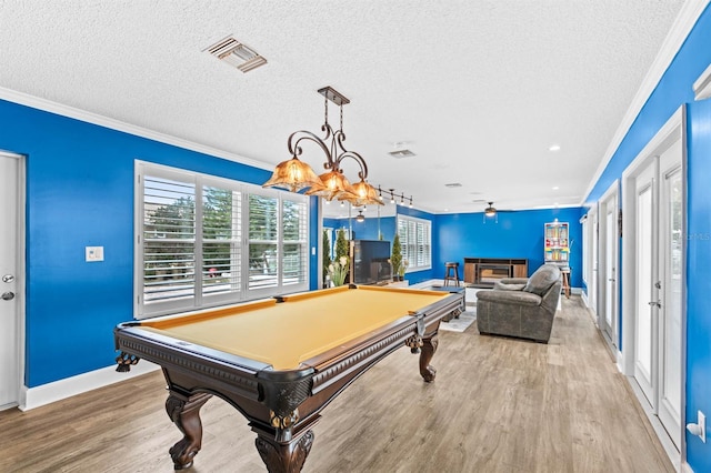 rec room with ornamental molding, billiards, light hardwood / wood-style flooring, and a textured ceiling