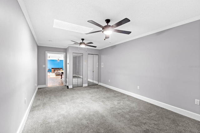 unfurnished bedroom with carpet floors, ceiling fan, and crown molding