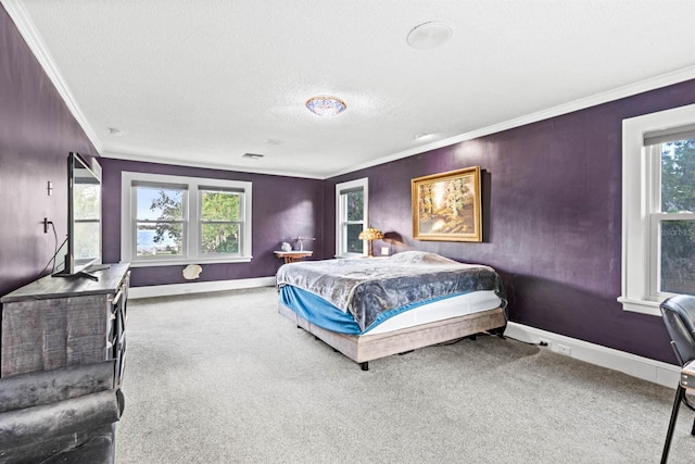 bedroom with a textured ceiling, carpet flooring, and crown molding