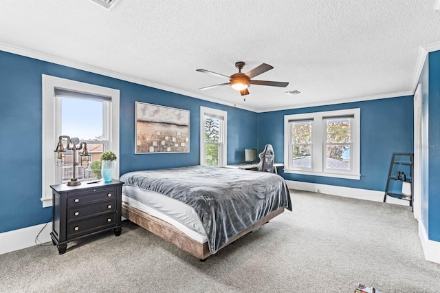 carpeted bedroom featuring a textured ceiling, ceiling fan, and crown molding