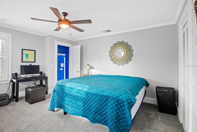 carpeted bedroom featuring a textured ceiling, ceiling fan, and crown molding