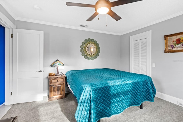 carpeted bedroom with a closet, ceiling fan, and crown molding