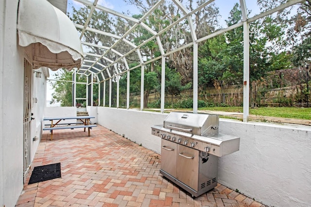 view of patio featuring grilling area and a lanai