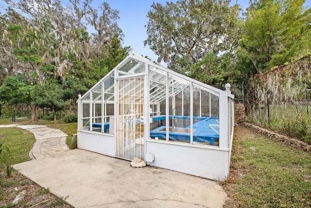 view of outdoor structure featuring a pool