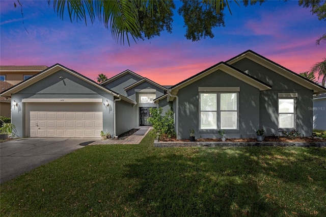 single story home featuring a yard and a garage