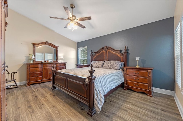 bedroom with hardwood / wood-style flooring, ceiling fan, and vaulted ceiling