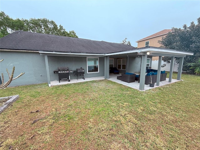 rear view of house with outdoor lounge area, a yard, and a patio area