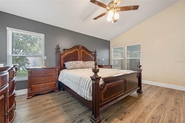 bedroom with multiple windows, wood-type flooring, vaulted ceiling, and ceiling fan