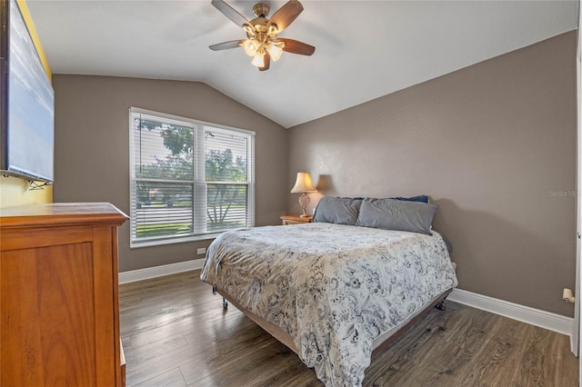 bedroom with ceiling fan, lofted ceiling, and dark hardwood / wood-style floors