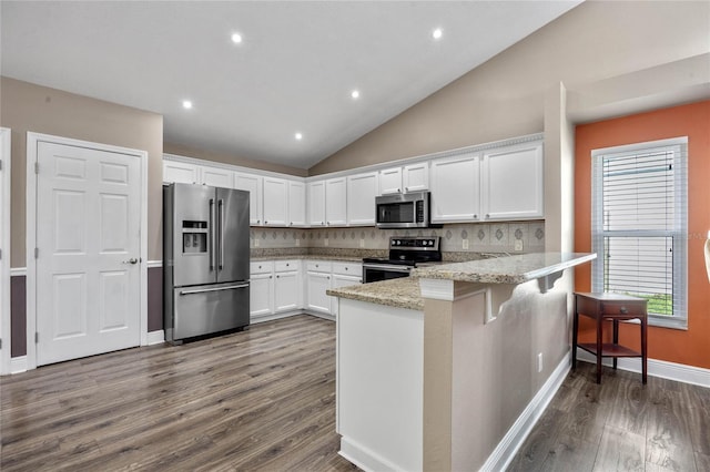 kitchen with tasteful backsplash, white cabinets, kitchen peninsula, stainless steel appliances, and light stone countertops