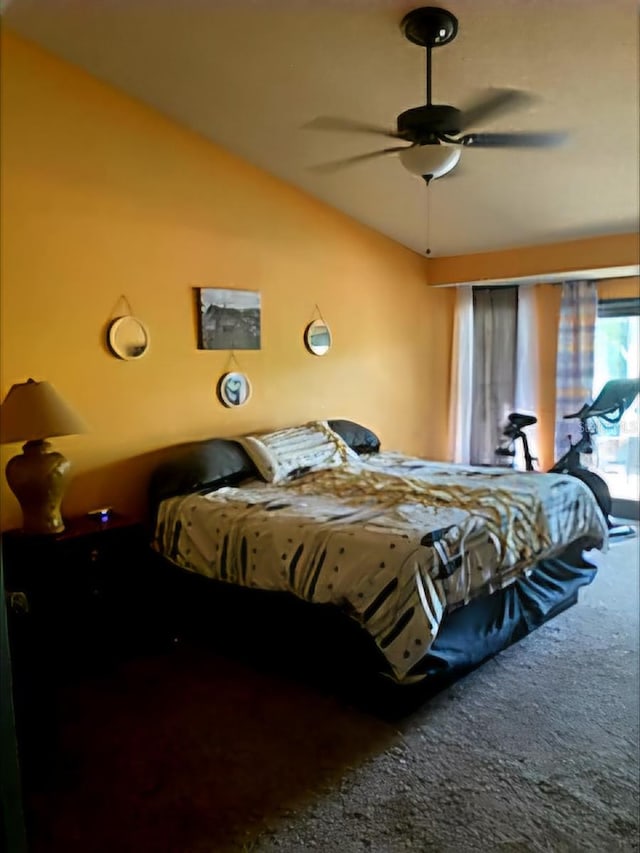 bedroom featuring ceiling fan, carpet floors, and vaulted ceiling