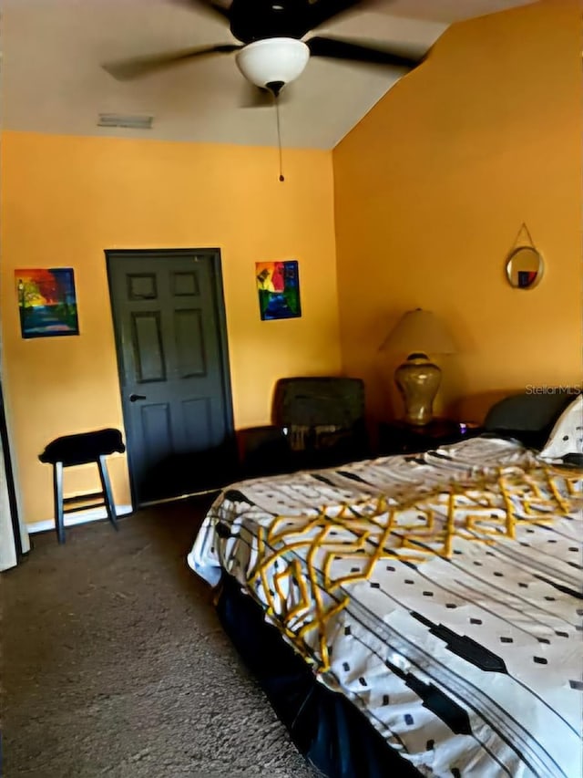 carpeted bedroom featuring ceiling fan and vaulted ceiling