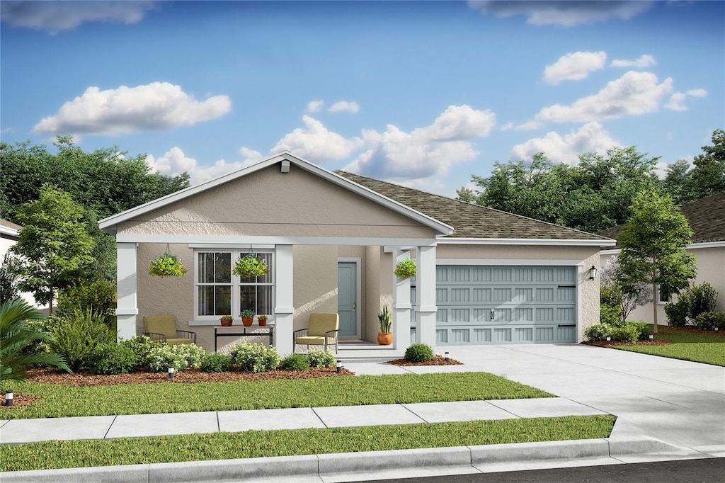 view of front of home featuring a garage and a front lawn