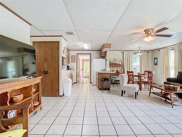 living room with ceiling fan and light tile patterned floors