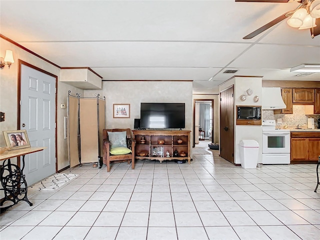 living room featuring ceiling fan, light tile patterned flooring, and a barn door