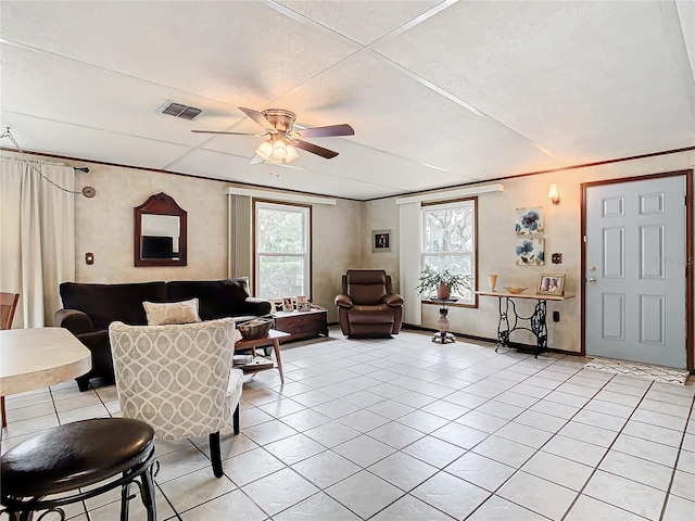 tiled living room with ceiling fan