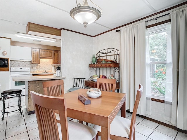 dining area with light tile patterned flooring and sink