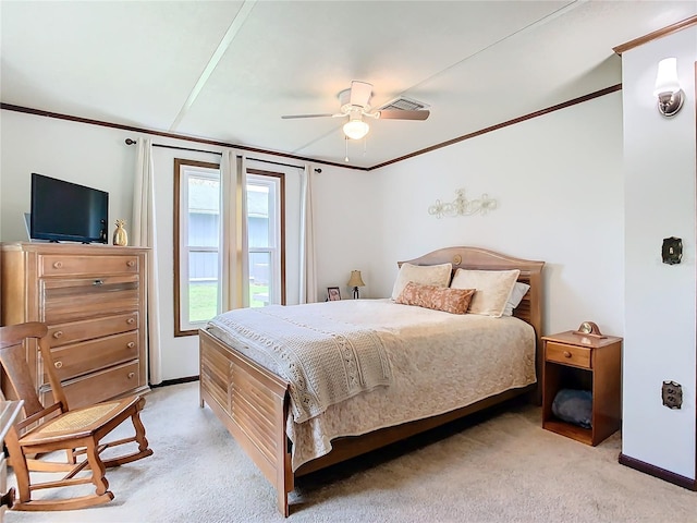 carpeted bedroom with ceiling fan and ornamental molding