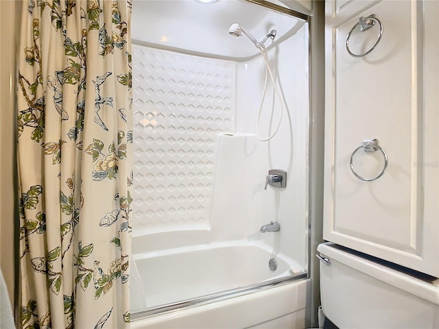 bathroom with shower / tub combo and toilet