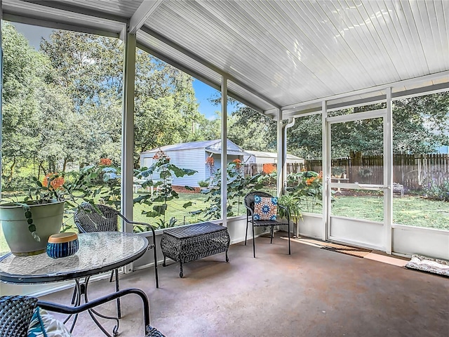 sunroom featuring vaulted ceiling