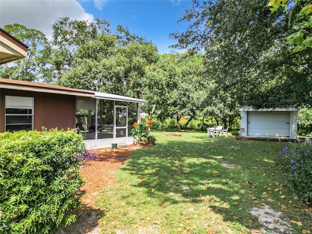 view of yard with a storage shed and a sunroom