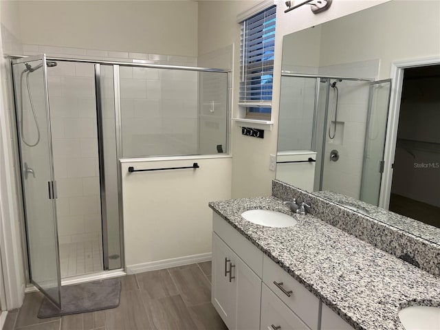 bathroom with an enclosed shower and vanity