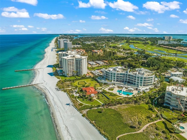 drone / aerial view with a water view and a beach view