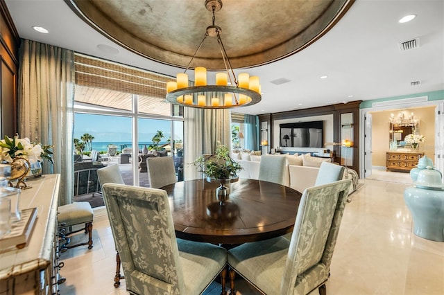 dining space with a wall of windows, a notable chandelier, and a raised ceiling