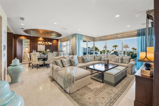 living room with an inviting chandelier and a tray ceiling