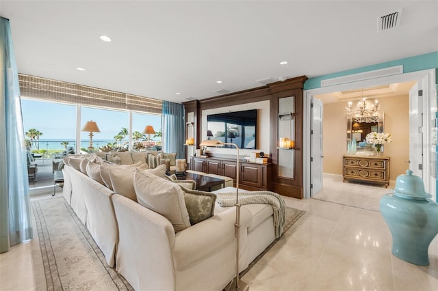 home theater room featuring an inviting chandelier and light tile patterned floors