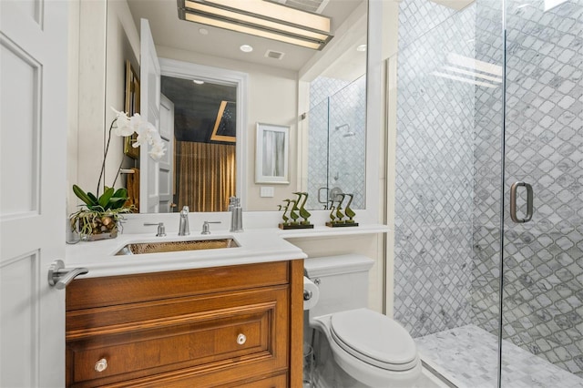 bathroom with walk in shower, vanity, and toilet