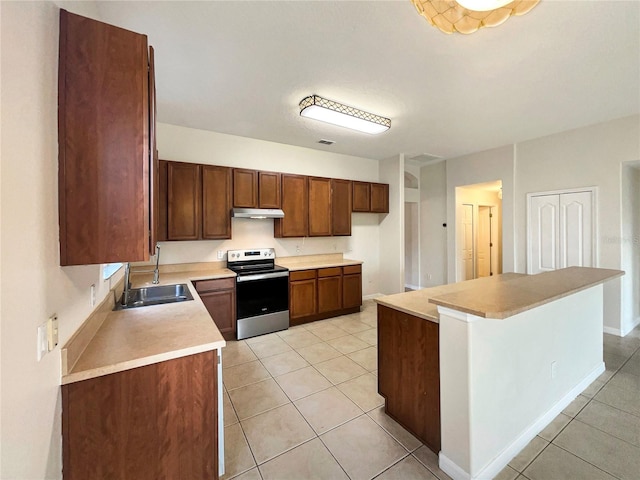 kitchen featuring stainless steel range with electric stovetop, light tile patterned flooring, sink, and a kitchen island