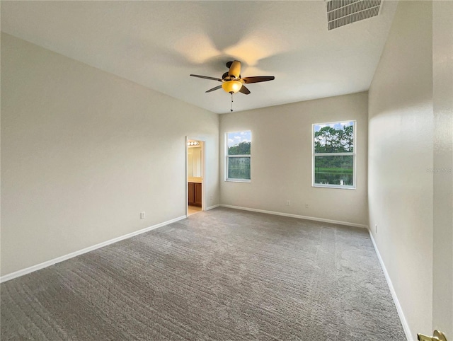 spare room featuring ceiling fan and carpet flooring