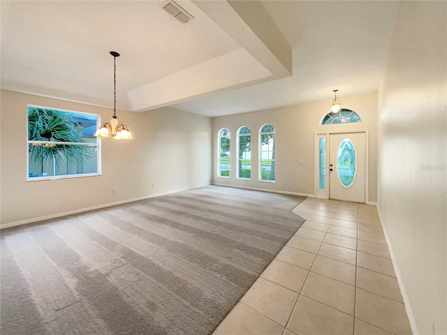 foyer with light tile patterned floors and a notable chandelier