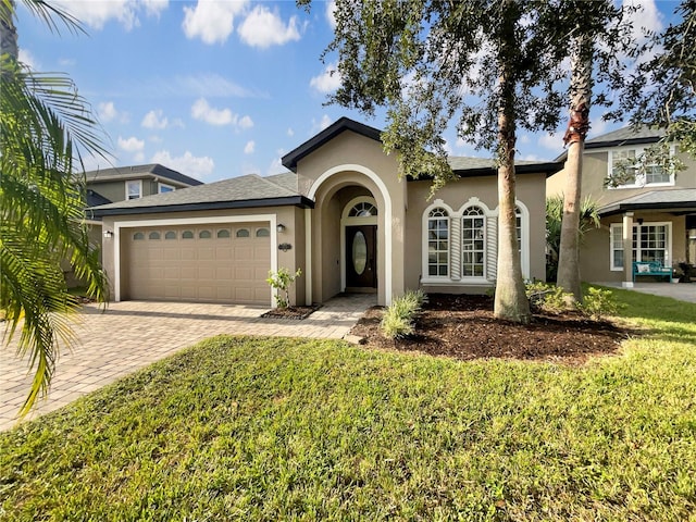 view of front of home with a front yard and a garage