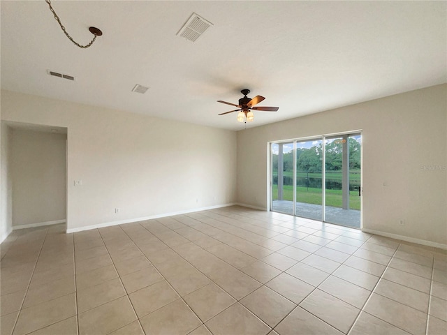 unfurnished room with ceiling fan and light tile patterned floors