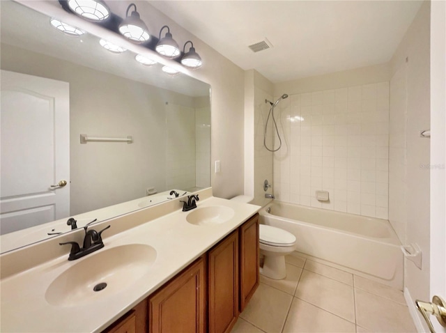 full bathroom with vanity, tiled shower / bath combo, toilet, and tile patterned flooring