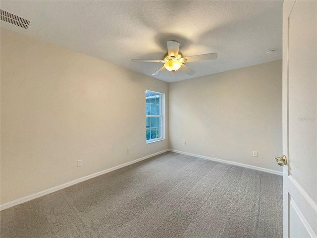 spare room with ceiling fan, carpet flooring, and a textured ceiling